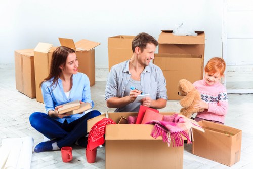 Driver loading household furniture into a moving van