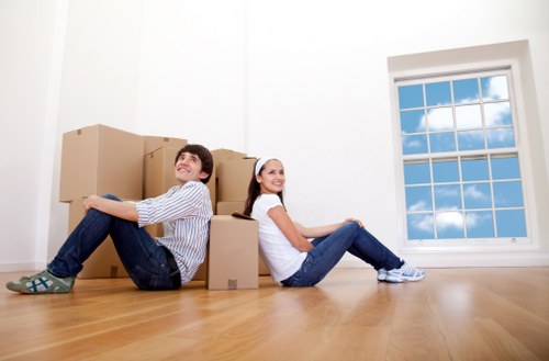 Movers carrying boxed household items during a local Newington relocation