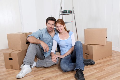 Local moving team preparing boxes in a Newington flat with limited access