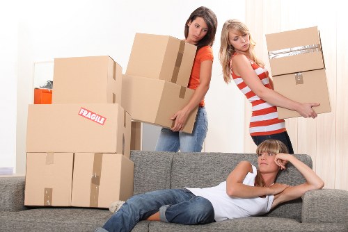 Packing and moving boxes inside a Newington apartment relocation